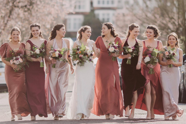 Bride and bridesmaids walking in a row